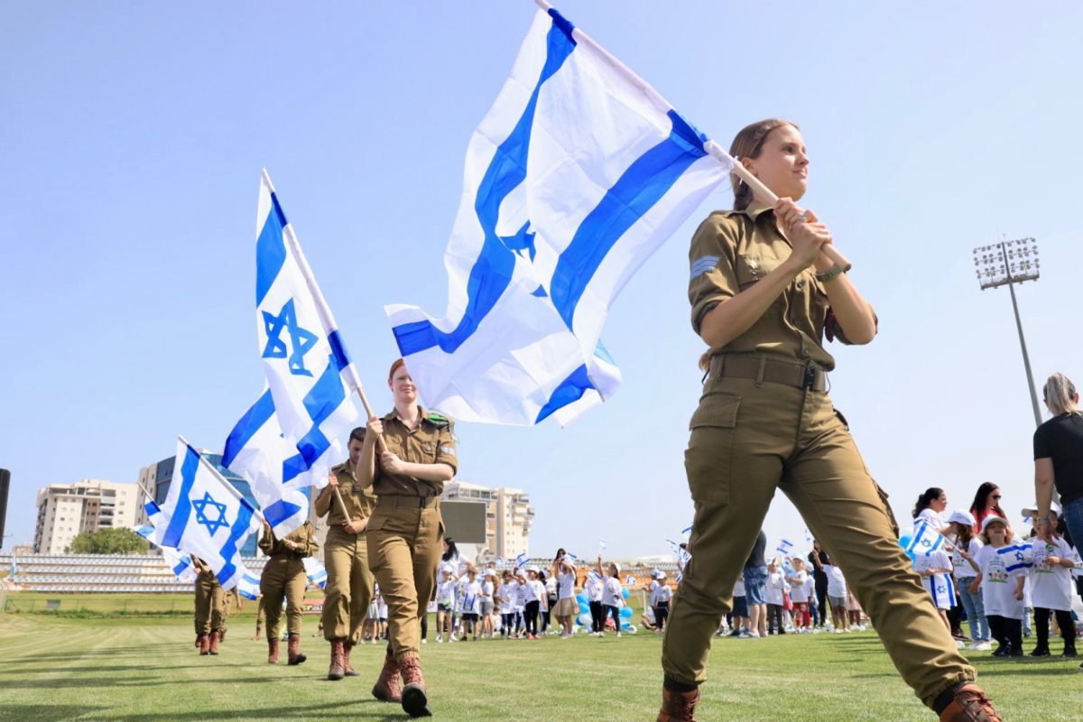 חיילים נושאים דגלי ישראל באצטדיון העירוני | צילום: אלדד עובדיה